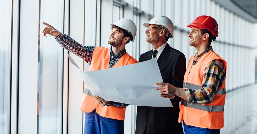 Construction estimator reviewing drawings for outsourced estimating project
