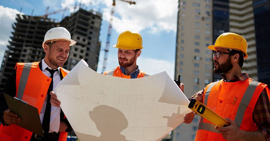 Construction estimator reviewing project cost breakdown on site